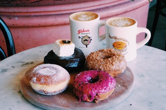 the best donuts in orange county on a board with coffee