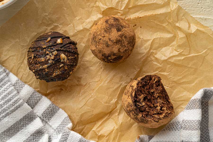 Half eaten truffle balls laid out on a parchment paper.