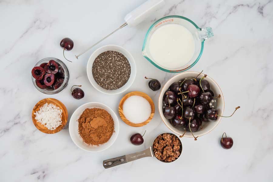 a table with ingredients for black forest chia pudding