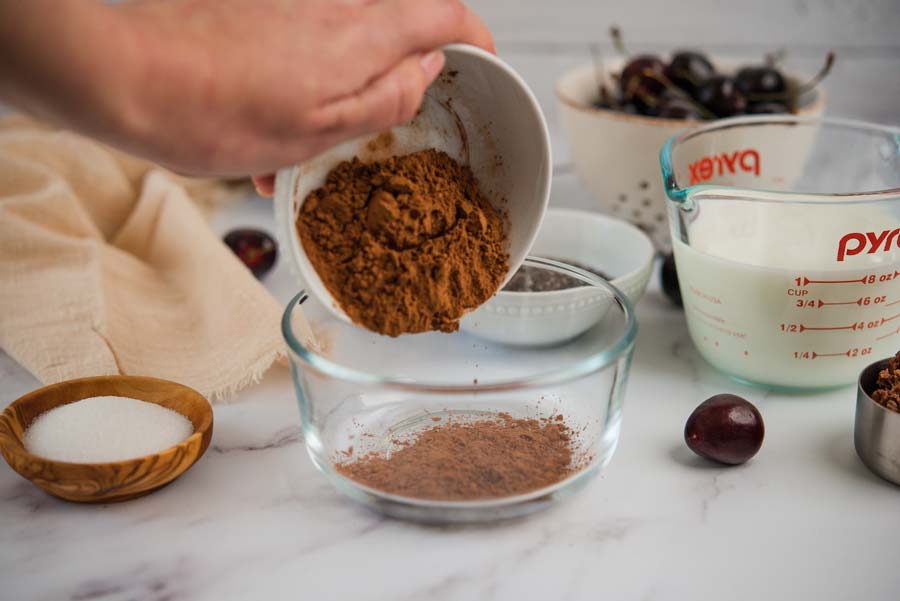 cocao powder being poured into a bowl