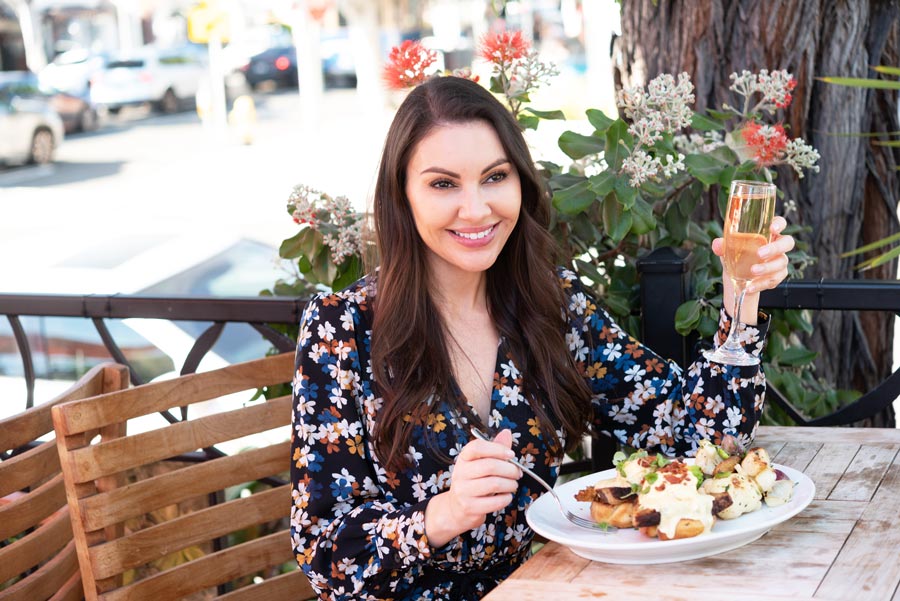 sondra barker at sapphire laguna beach eating pork belly Benedict