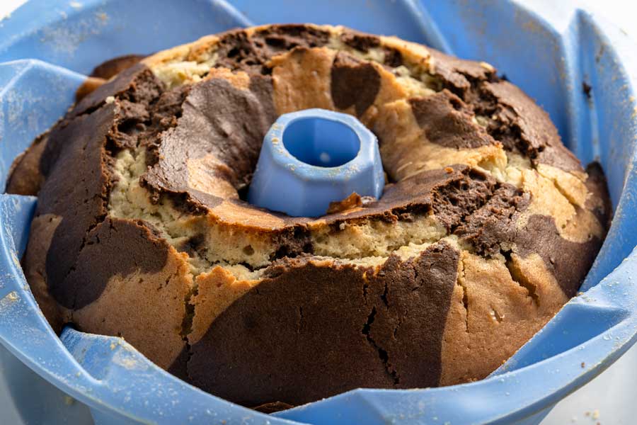 chocolate and orange cake baked in a blue bundt pan.