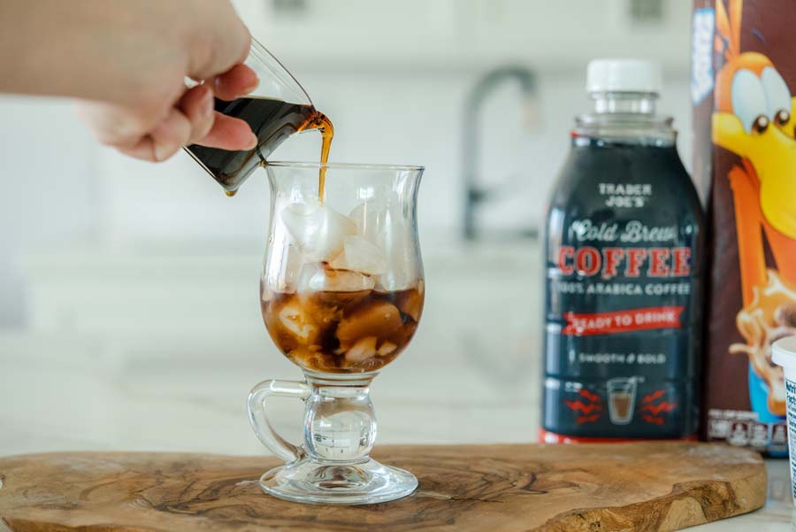 pouring cold brew coffee into coffee glass