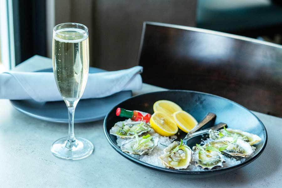 oysters with a glass of champagne on a table