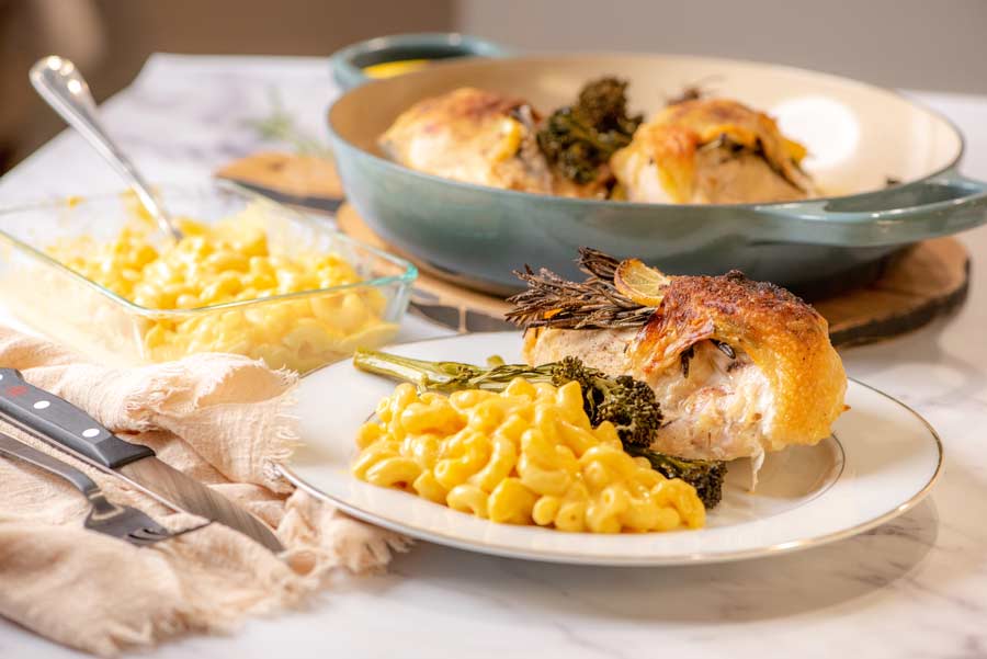 roasted rosemary lemon chicken on a plate with mac and cheese