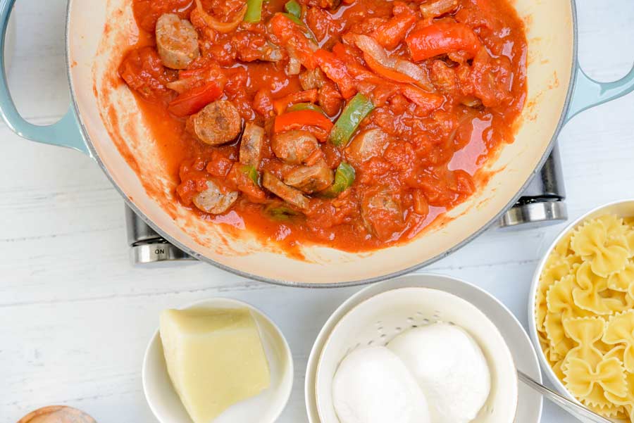 sausage peppers and marinara in a pan