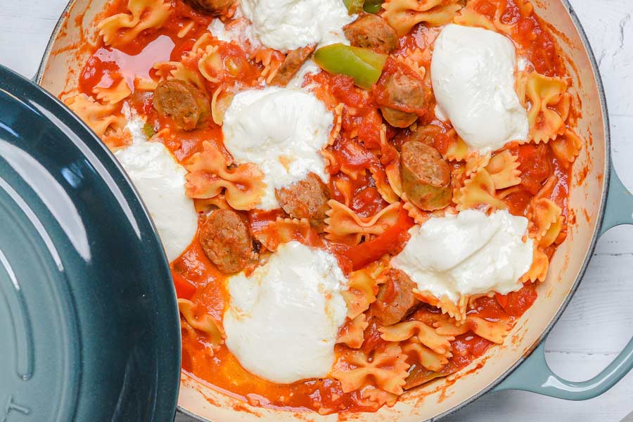 peppers sausage and pasta with burrata in a pan