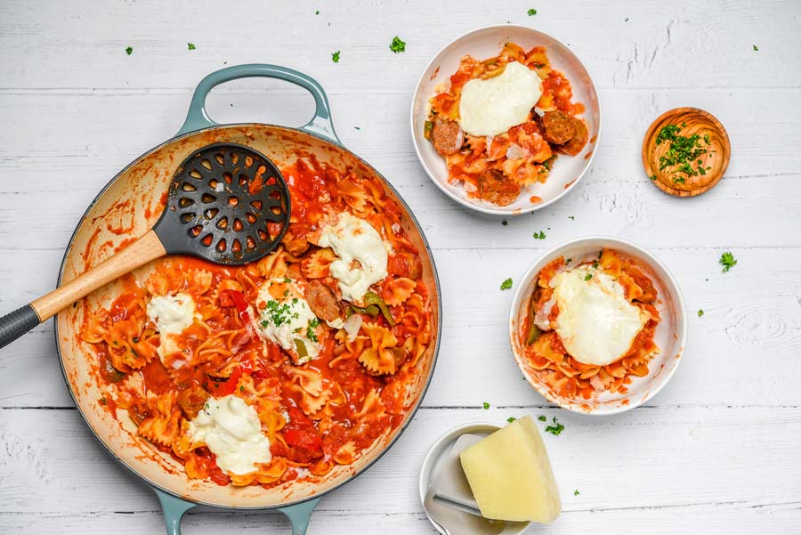 peppers sausage and pasta in pan and bowls