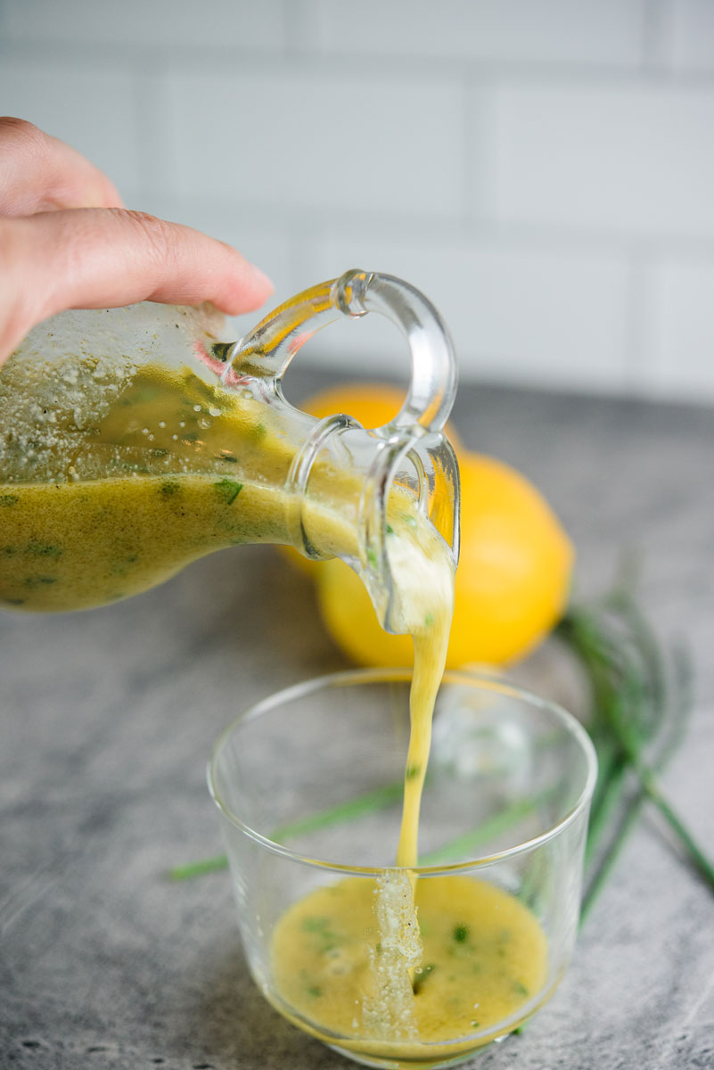 Lemon-herb-vinaigrette-being-poured-