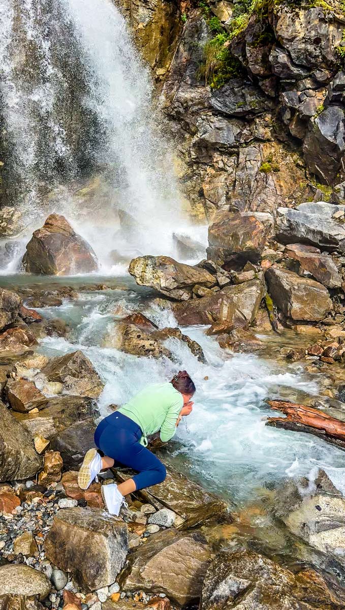 White Pass Railroad & Yukon Suspension Bridge: A Must-Do Excursion in Skagway, Alaska 16 Drinking-from-Waterfall-in-Skagway